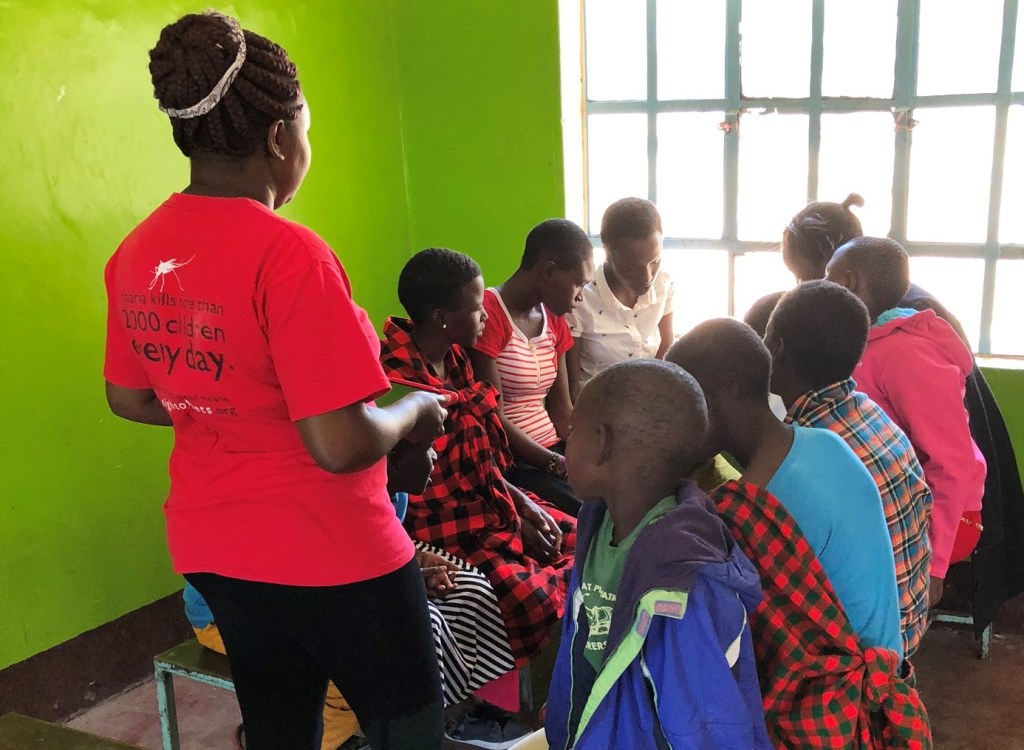 Children in Maasai Mara, Kenya read from an EmpowerReader tablet